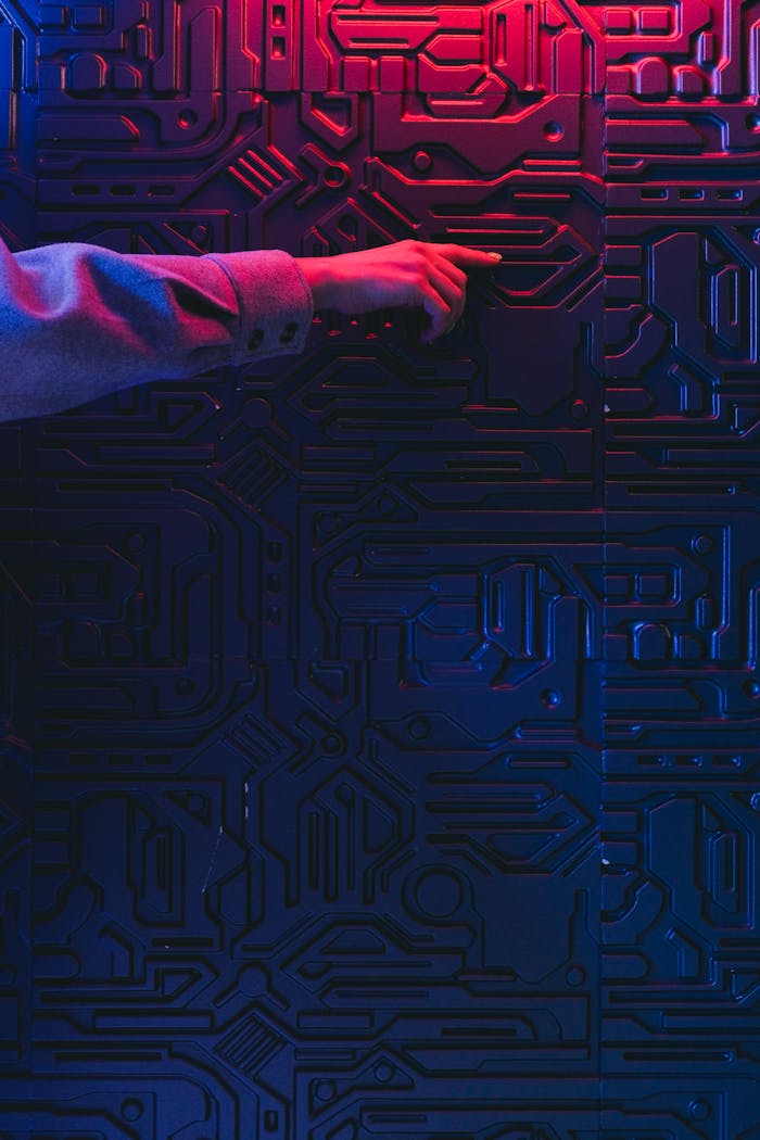 A person's hand interacting with a glowing circuit board, creating a modern tech ambiance.